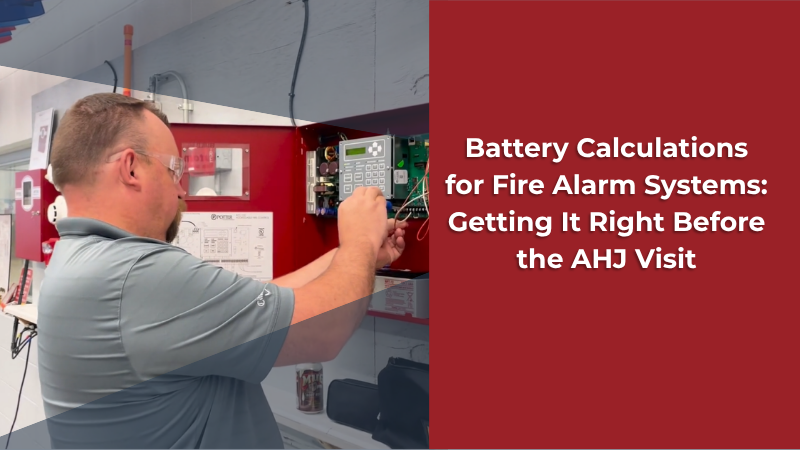 A service technician works on a fire alarm panel. Text overlay reads "Battery Calculations for Fire Alarm Panesl: Getting It Right Beore the AHJ Visit