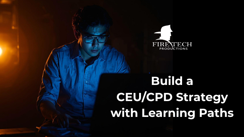 A fire protection professional sits in a dark room, face illuminated by his laptop.